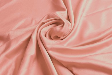 Pink shiny fabric as background, closeup view