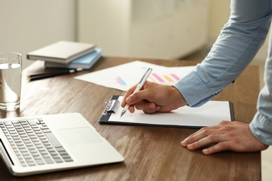 Photo of Business trainer working at table in office, closeup