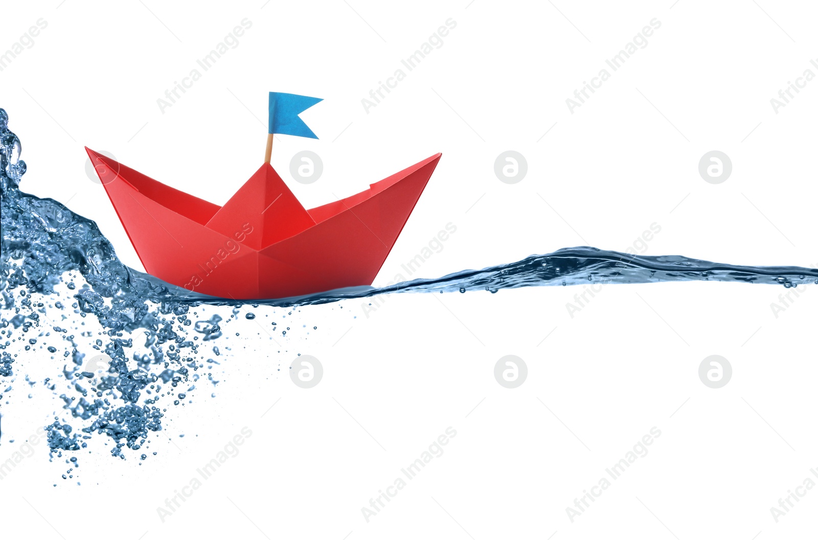 Image of Handmade red paper boat floating on clear water against white background 