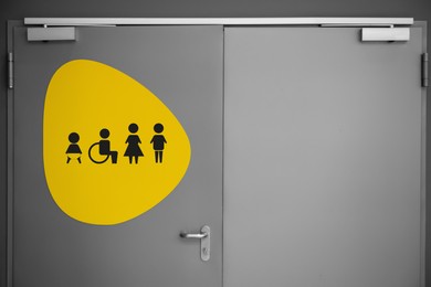 Image of Public toilet sign with symbols on door