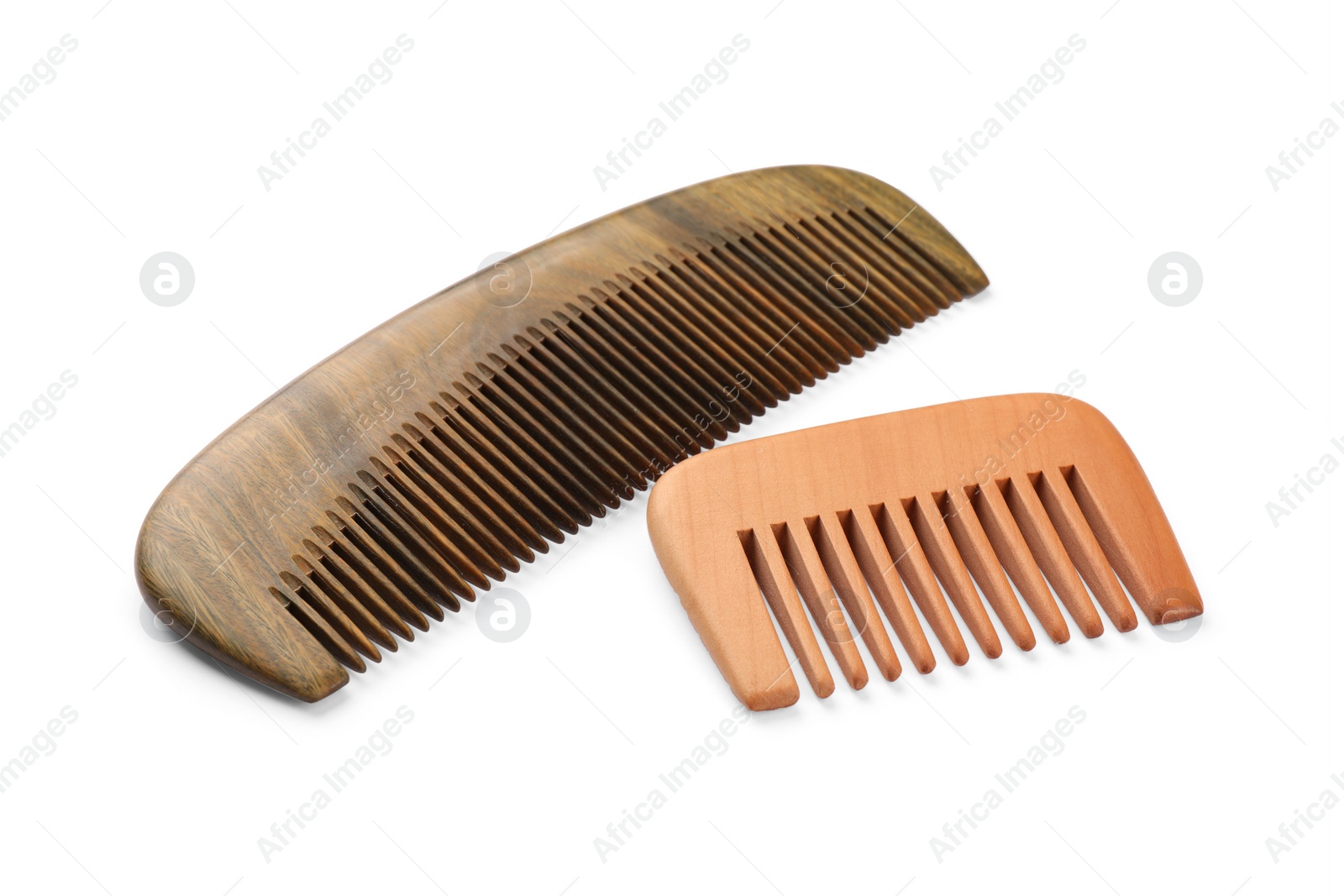 Photo of New wooden hair combs isolated on white