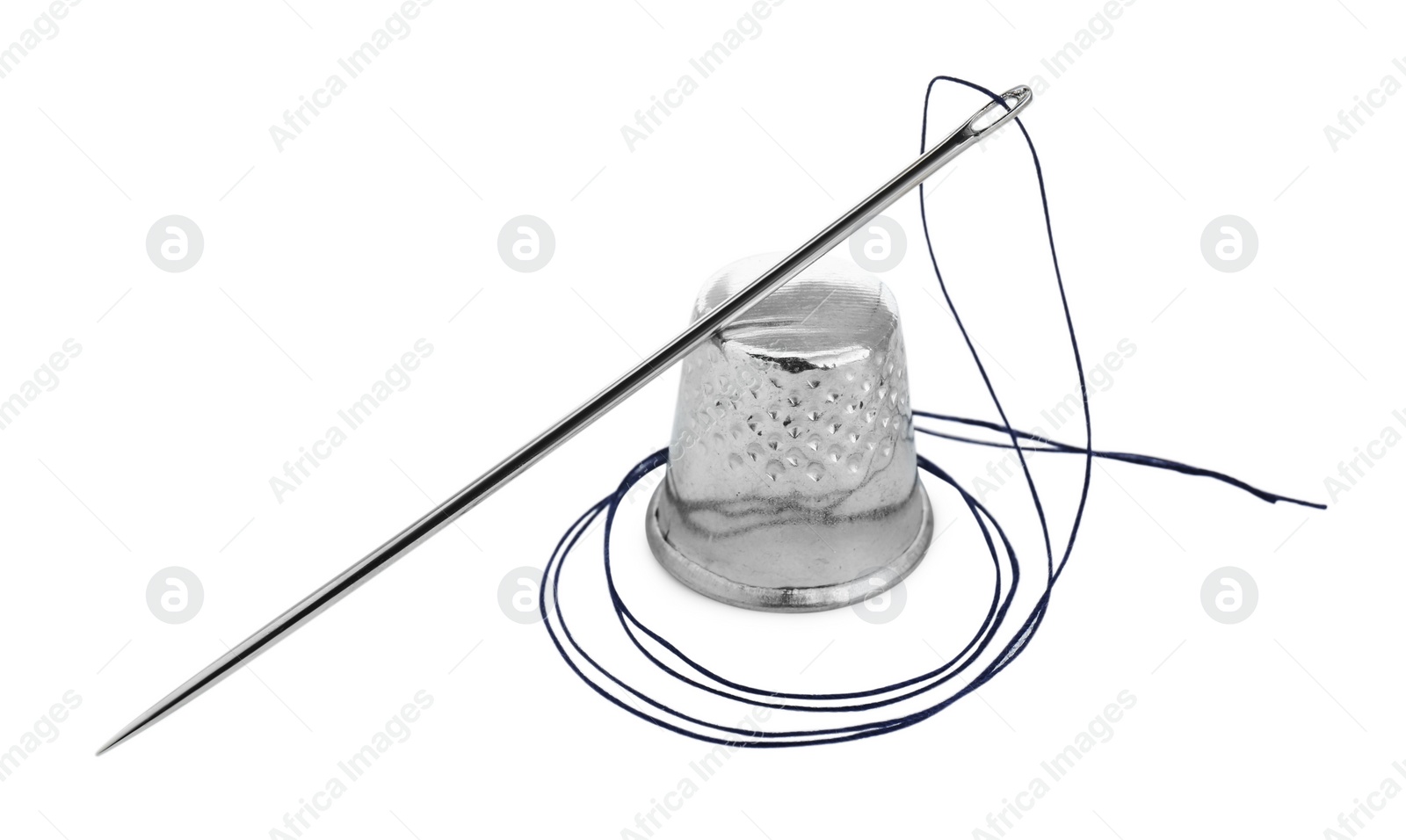 Photo of Thimble and needle with sewing thread isolated on white