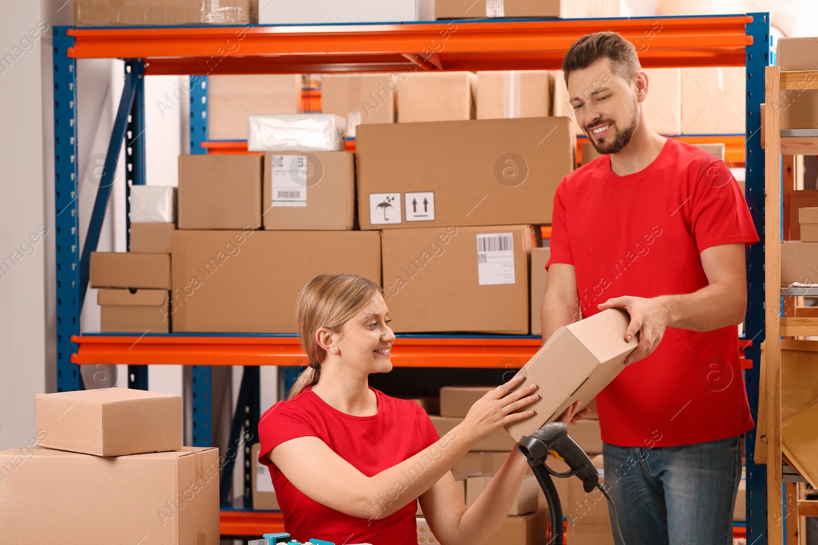 Photo of Man giving parcel to woman at post office