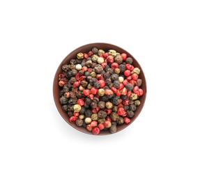 Bowl with different pepper grains on white background, top view