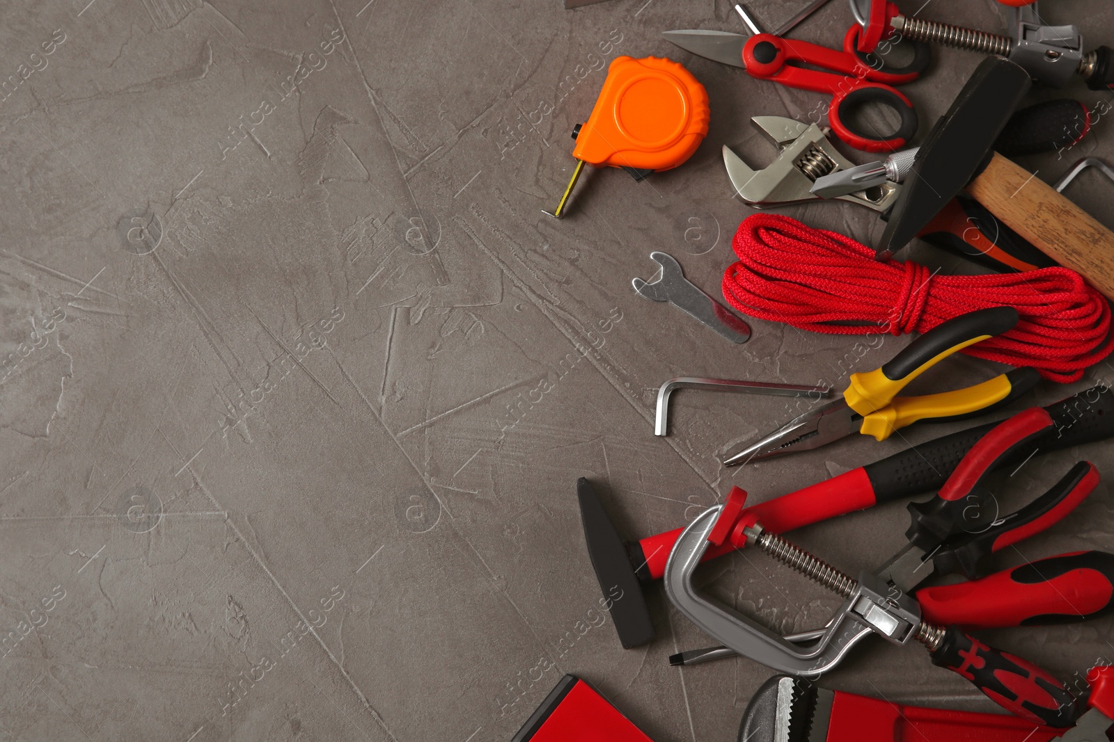 Photo of Flat lay composition with repair tools on grey stone table, space for text