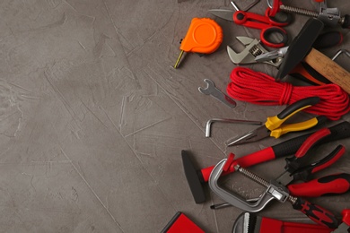 Photo of Flat lay composition with repair tools on grey stone table, space for text