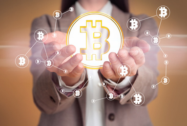 Image of Fintech concept. Woman demonstrating scheme with bitcoin symbols