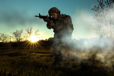Image of Soldier with machine gun on battlefield. War conflict