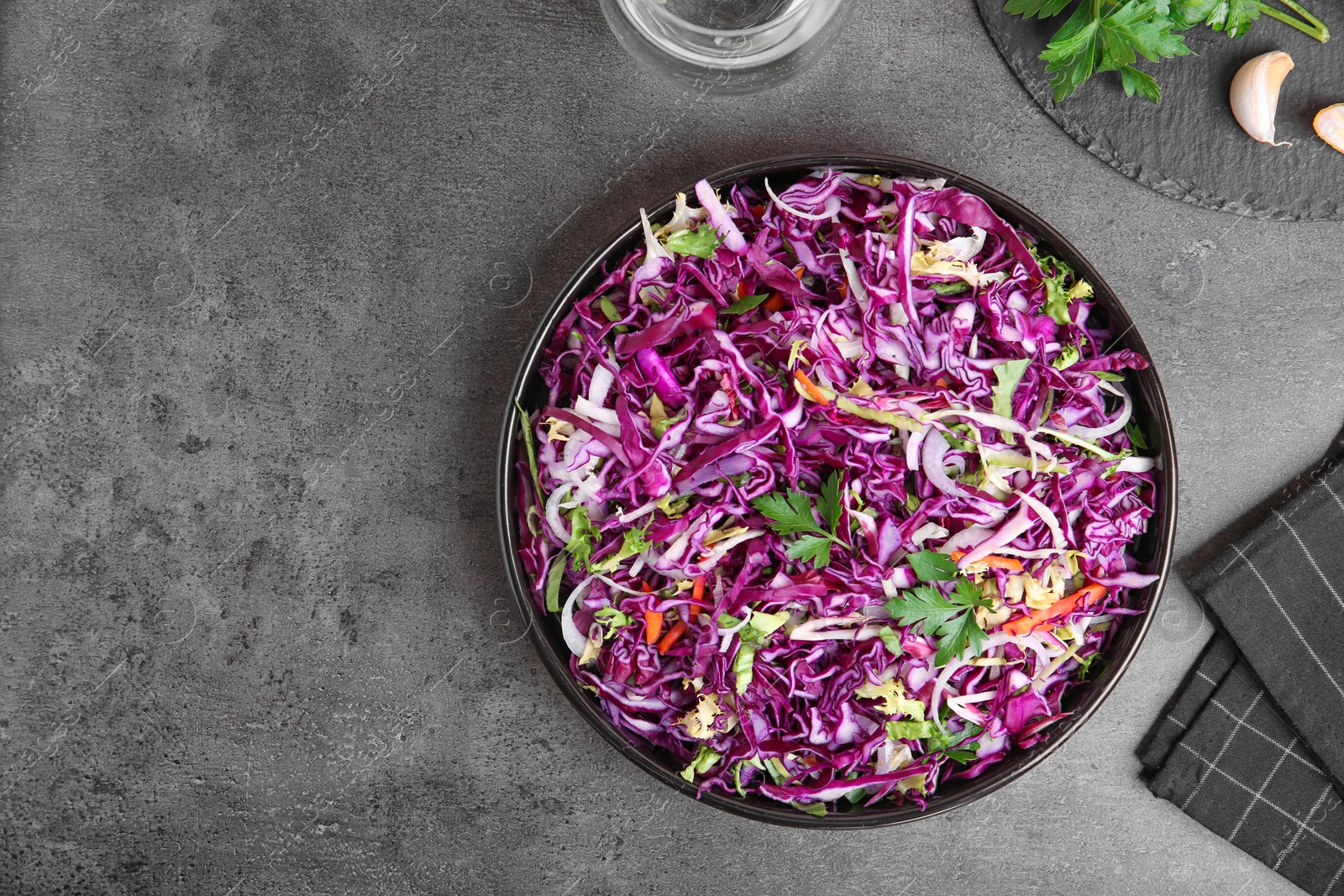 Photo of Bowl with chopped red cabbage on table, top view