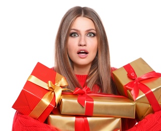 Emotional young woman with Christmas gifts on white background