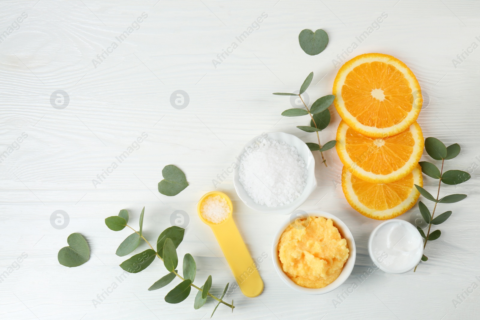 Photo of Homemade cosmetic products and fresh ingredients on white wooden table, flat lay. Space for text