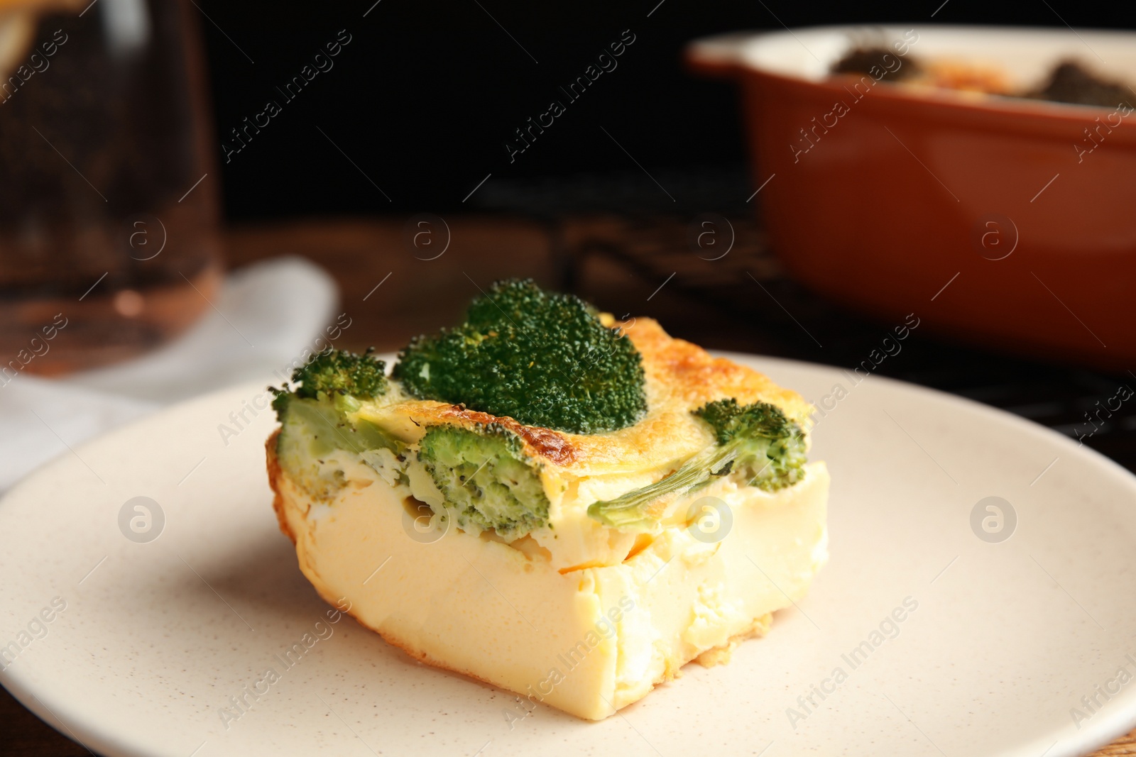 Photo of Tasty broccoli casserole on ceramic plate, closeup