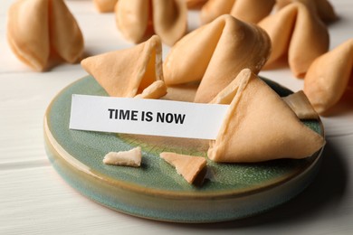 Tasty fortune cookie with prediction Time is now on white wooden table, closeup