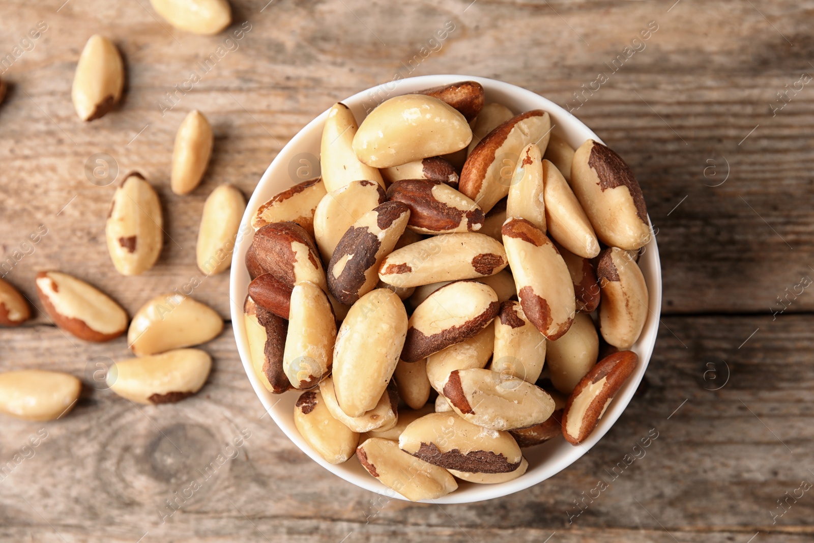 Photo of Composition with tasty Brazil nuts on wooden background, top view