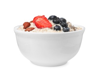 Photo of Tasty boiled oatmeal with berries, almonds and chia seeds in bowl isolated on white