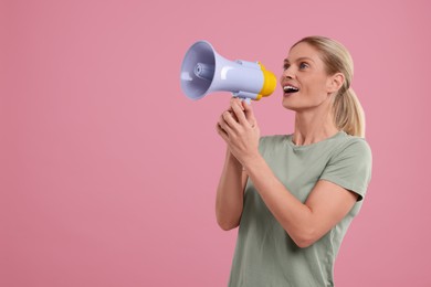 Special promotion. Woman shouting in megaphone on pink background. Space for text