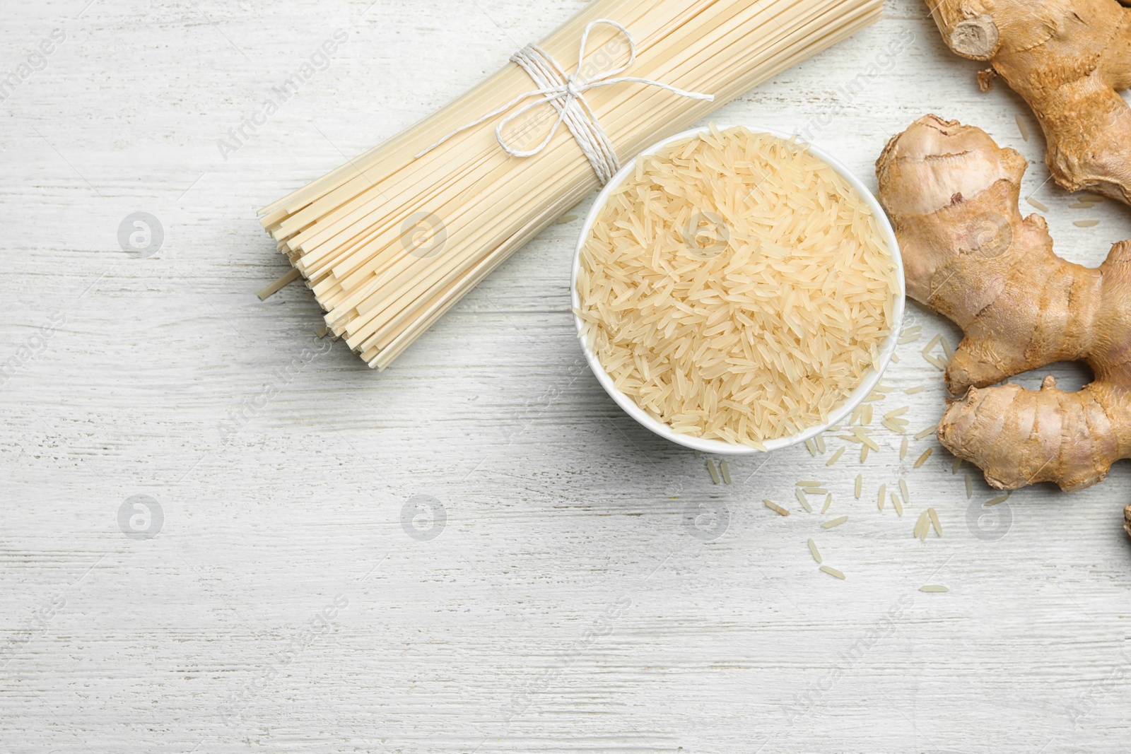 Photo of Flat lay composition with rice noodles on white wooden  table, space for text