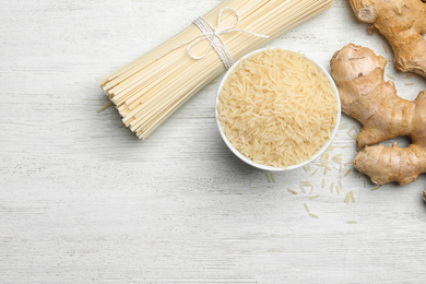 Photo of Flat lay composition with rice noodles on white wooden  table, space for text