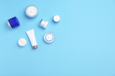 Photo of Flat lay composition with cosmetic products on color background