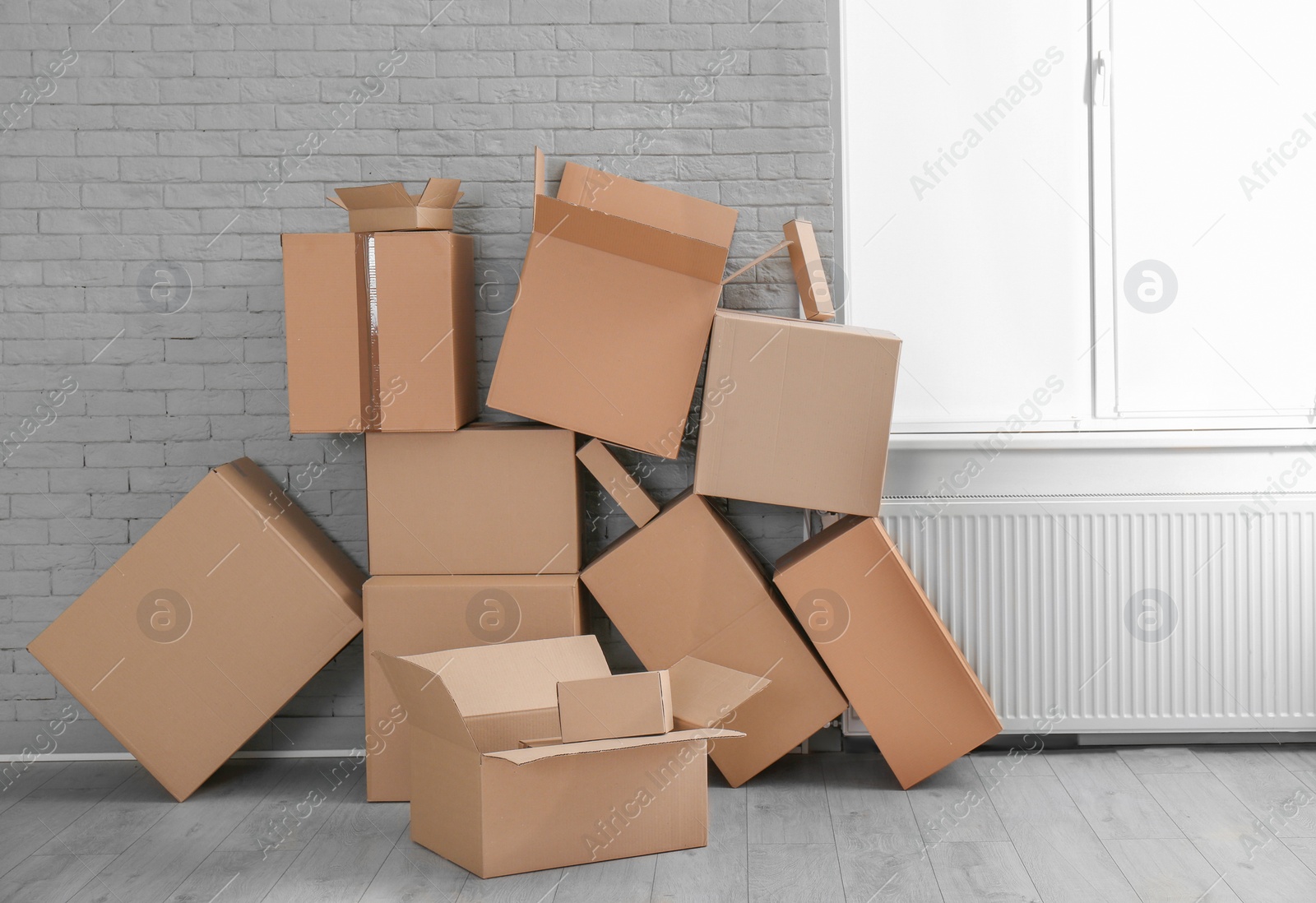 Photo of Cardboard boxes on floor indoors