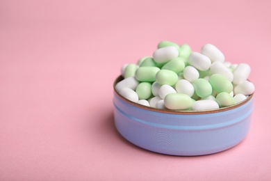 Open box with tasty mint candies on color background