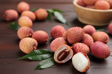 Fresh ripe lychee fruits on wooden table