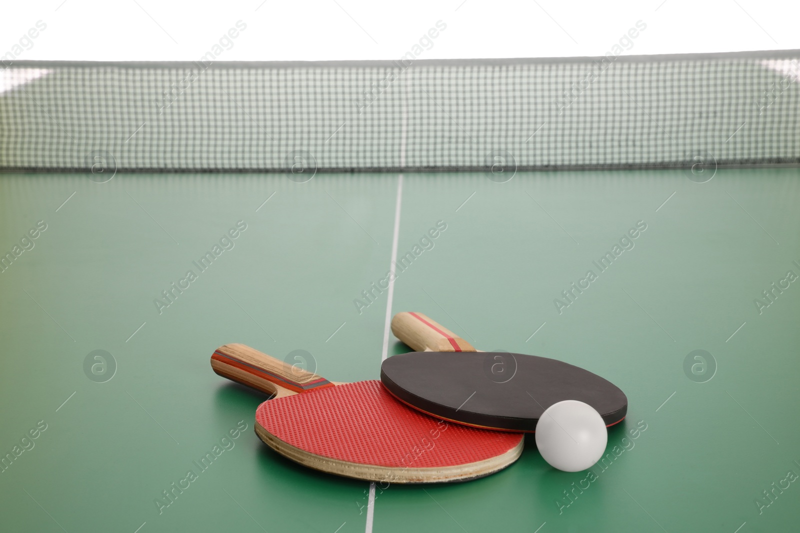 Photo of Rackets and ball on ping pong table