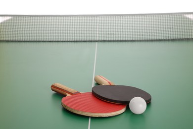 Rackets and ball on ping pong table