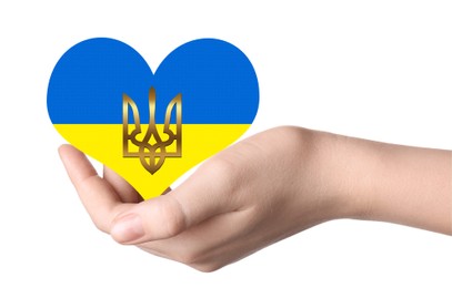 Stop war in Ukraine. Woman holding heart shaped symbol with colors of Ukrainian flag and Tryzub in hand on white background, closeup