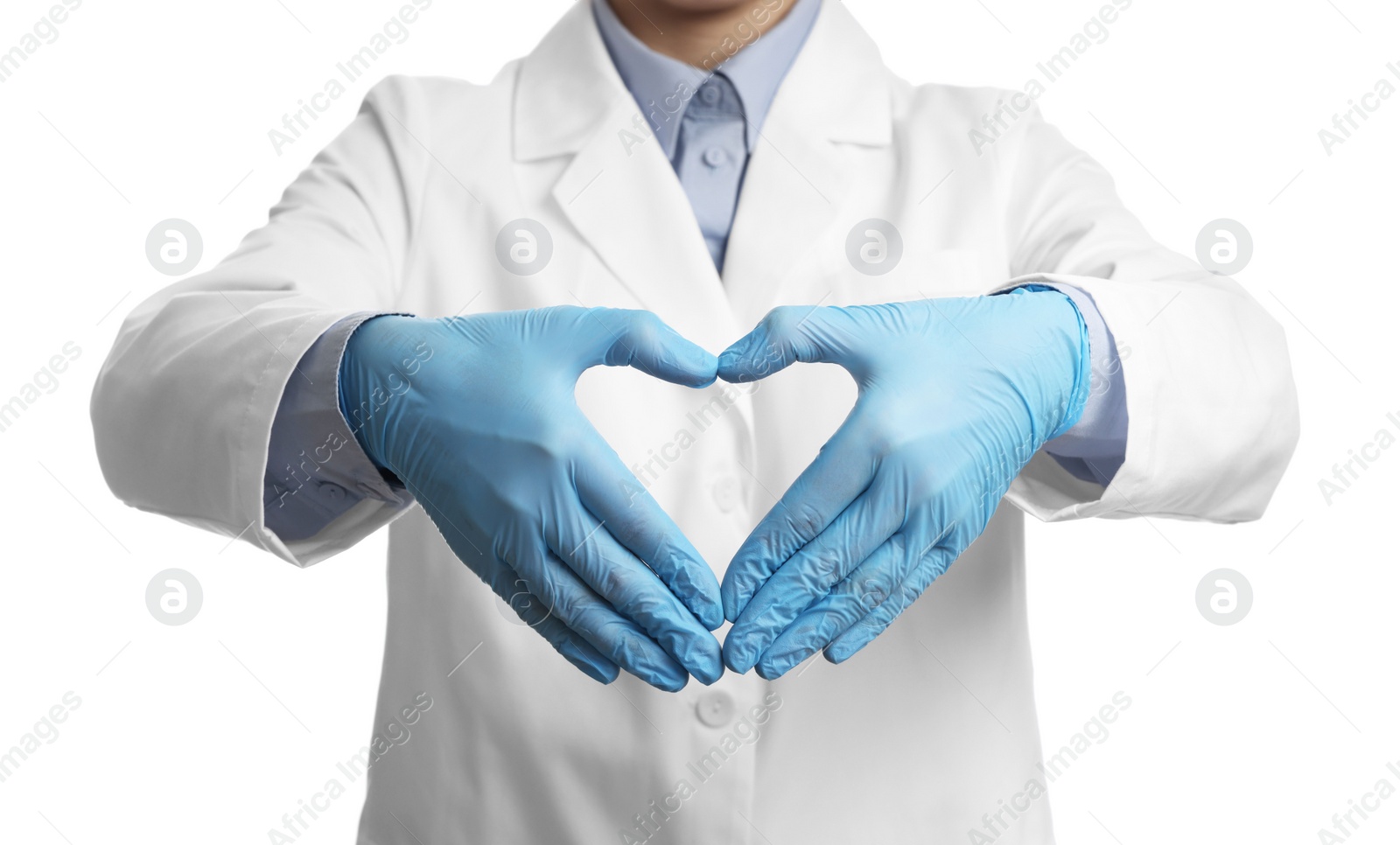 Photo of Doctor wearing light blue medical gloves making heart gesture on white background, closeup