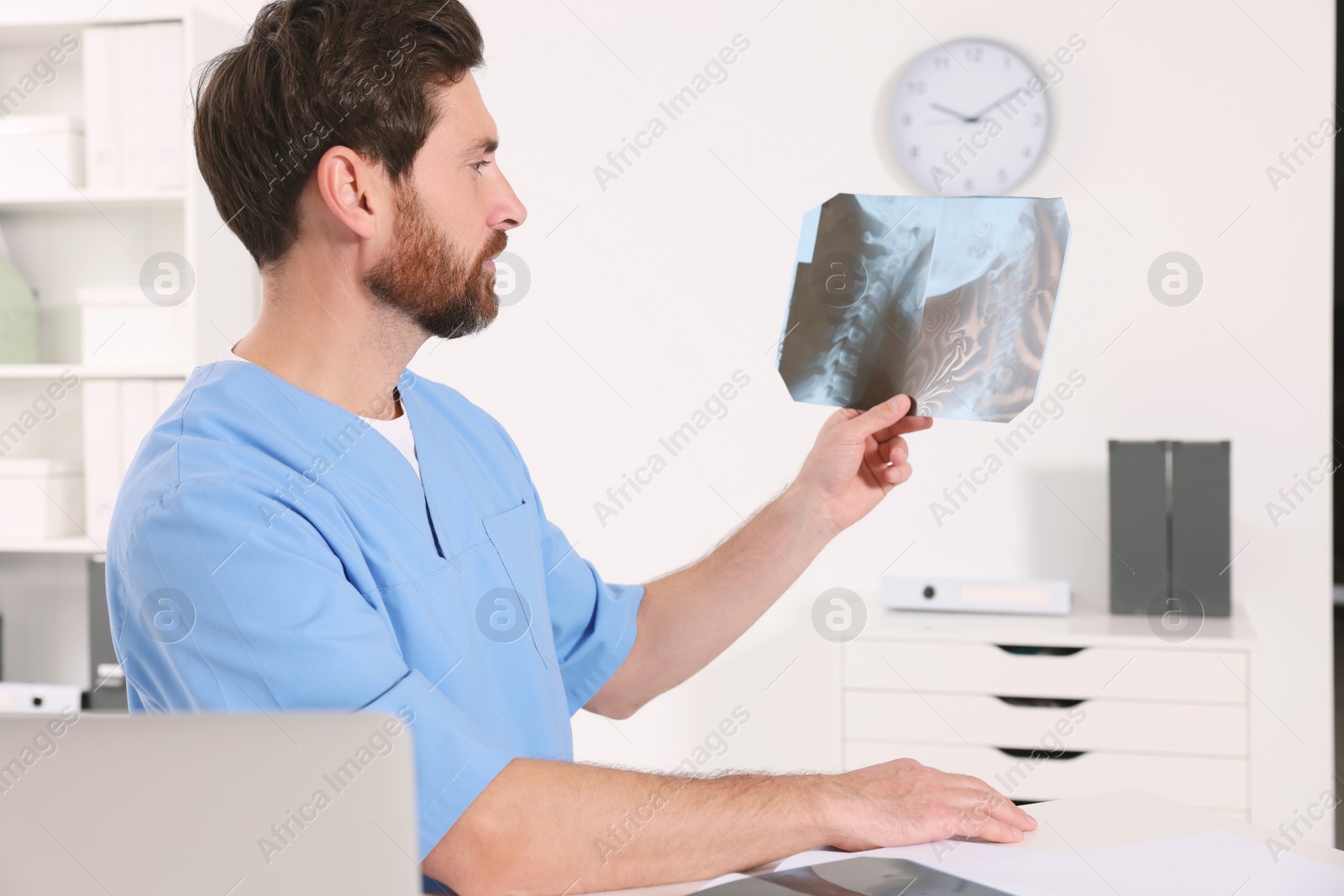 Photo of Doctor examining neck MRI scan in hospital