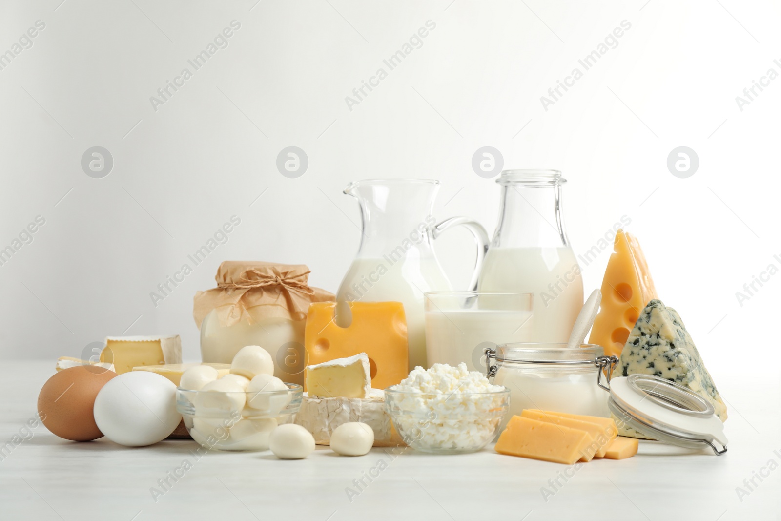 Photo of Different delicious dairy products on white table