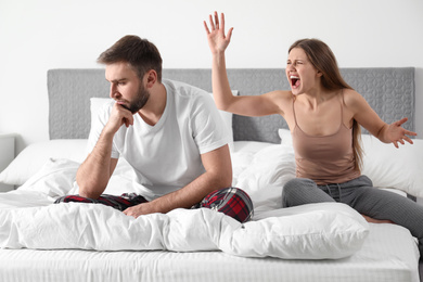 Photo of Unhappy young couple quarreling at home. Relationship problems