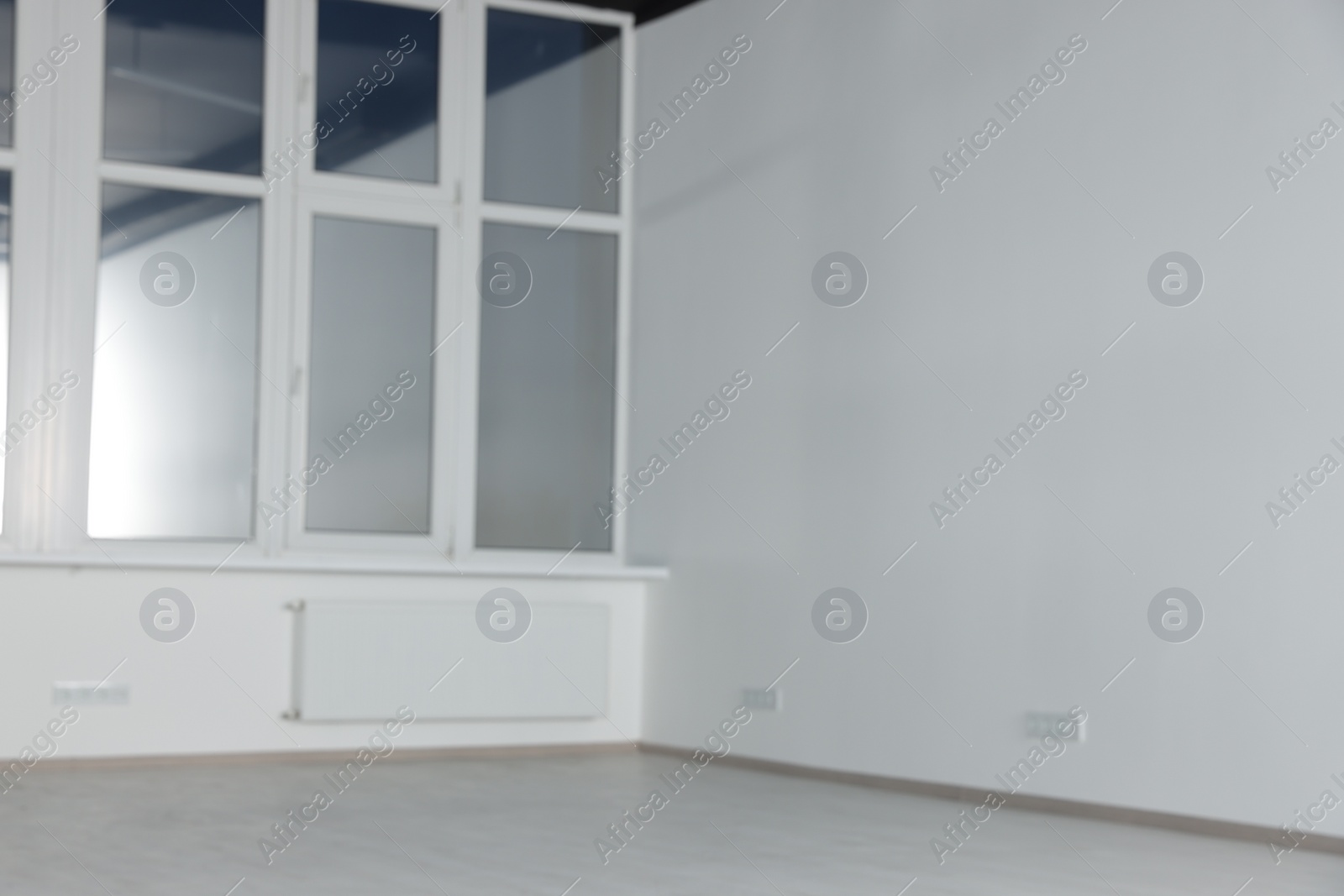 Photo of Blurred view of empty office room with clean window and white walls. Interior design