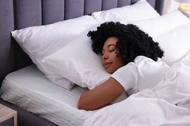 Photo of Beautiful young woman sleeping in soft bed