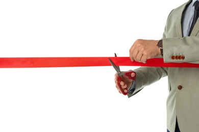 Photo of Man in office suit cutting red ribbon isolated on white, closeup