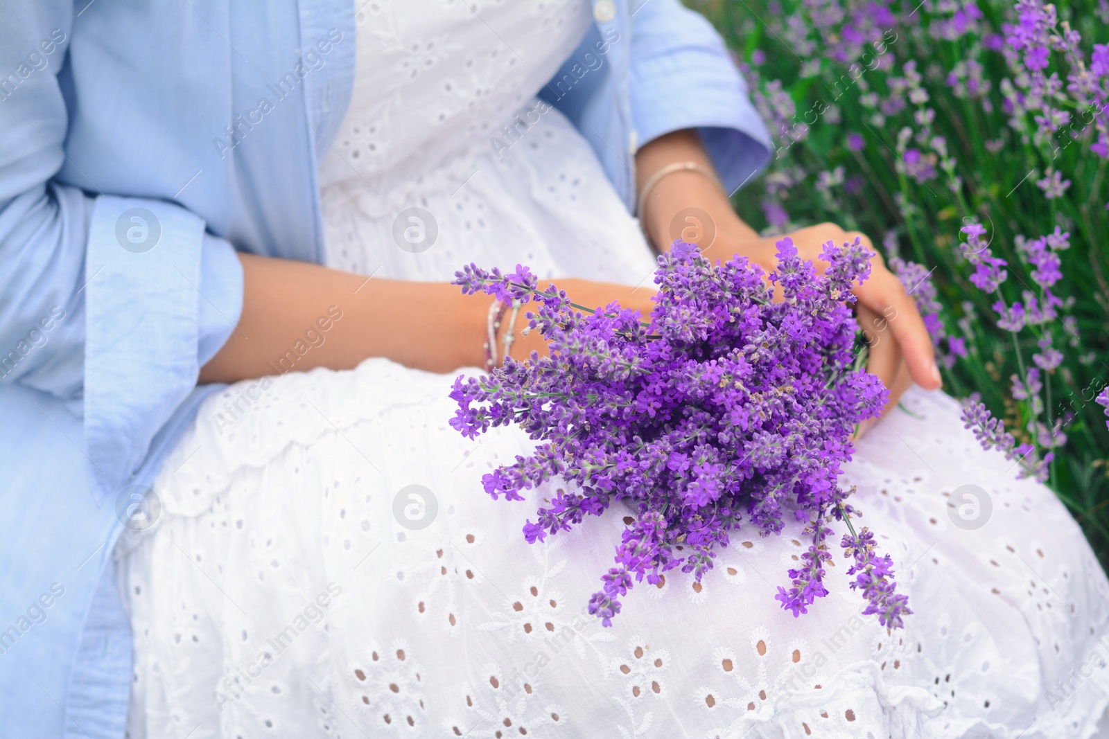 Photo of Woman with bouquet of beautiful lavender flowers outdoors, closeup