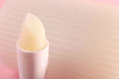 Photo of One lip balm against blurred background, closeup. Space for text