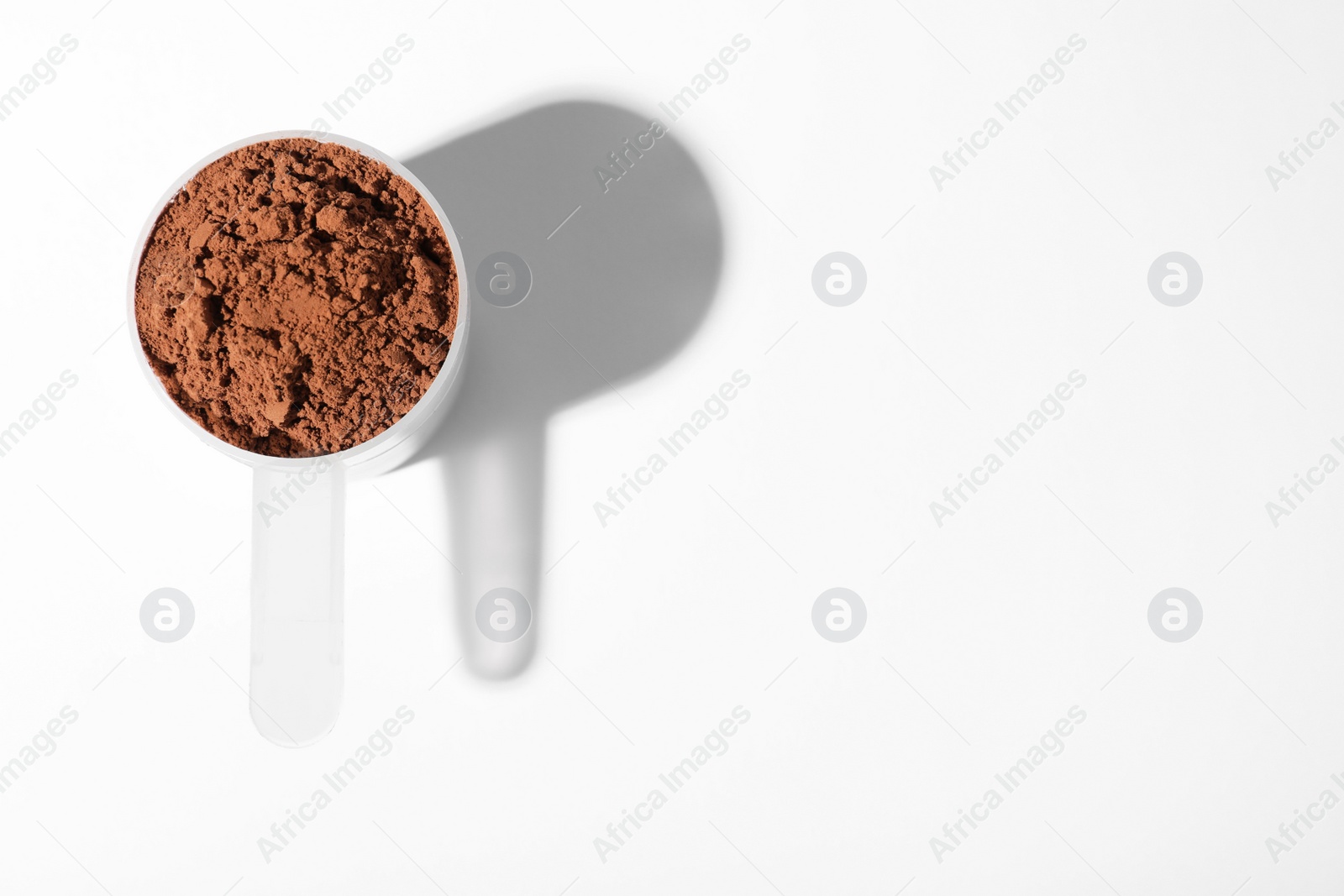 Photo of Scoop of protein powder on white background, top view