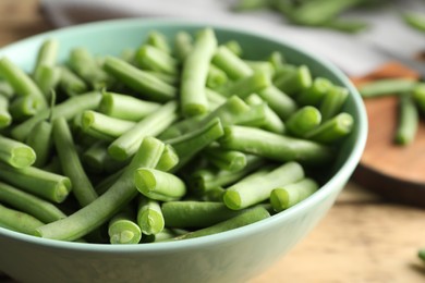 Photo of Fresh green beans in bowl, closeup view