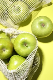 Ripe apples on light green background, flat lay