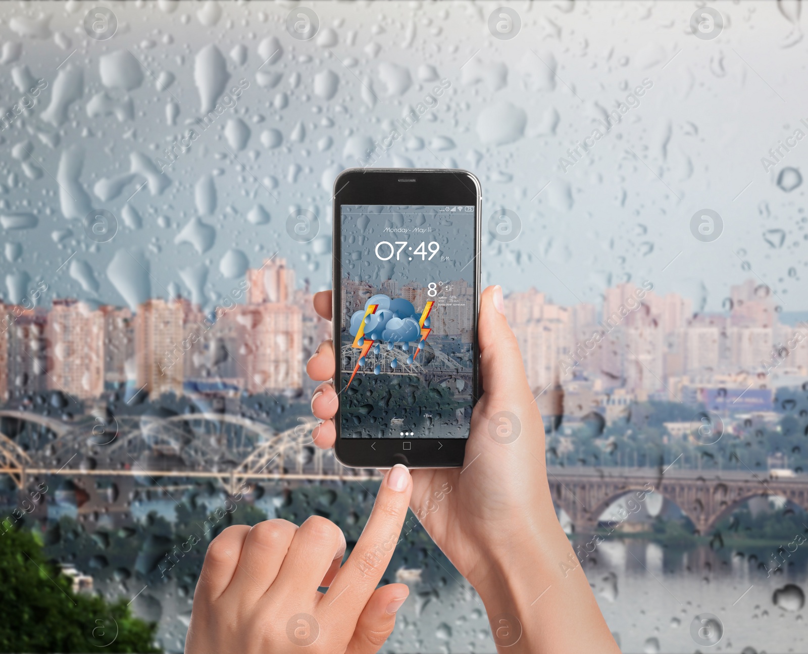 Image of Woman using weather forecast app on smartphone near window indoors, closeup