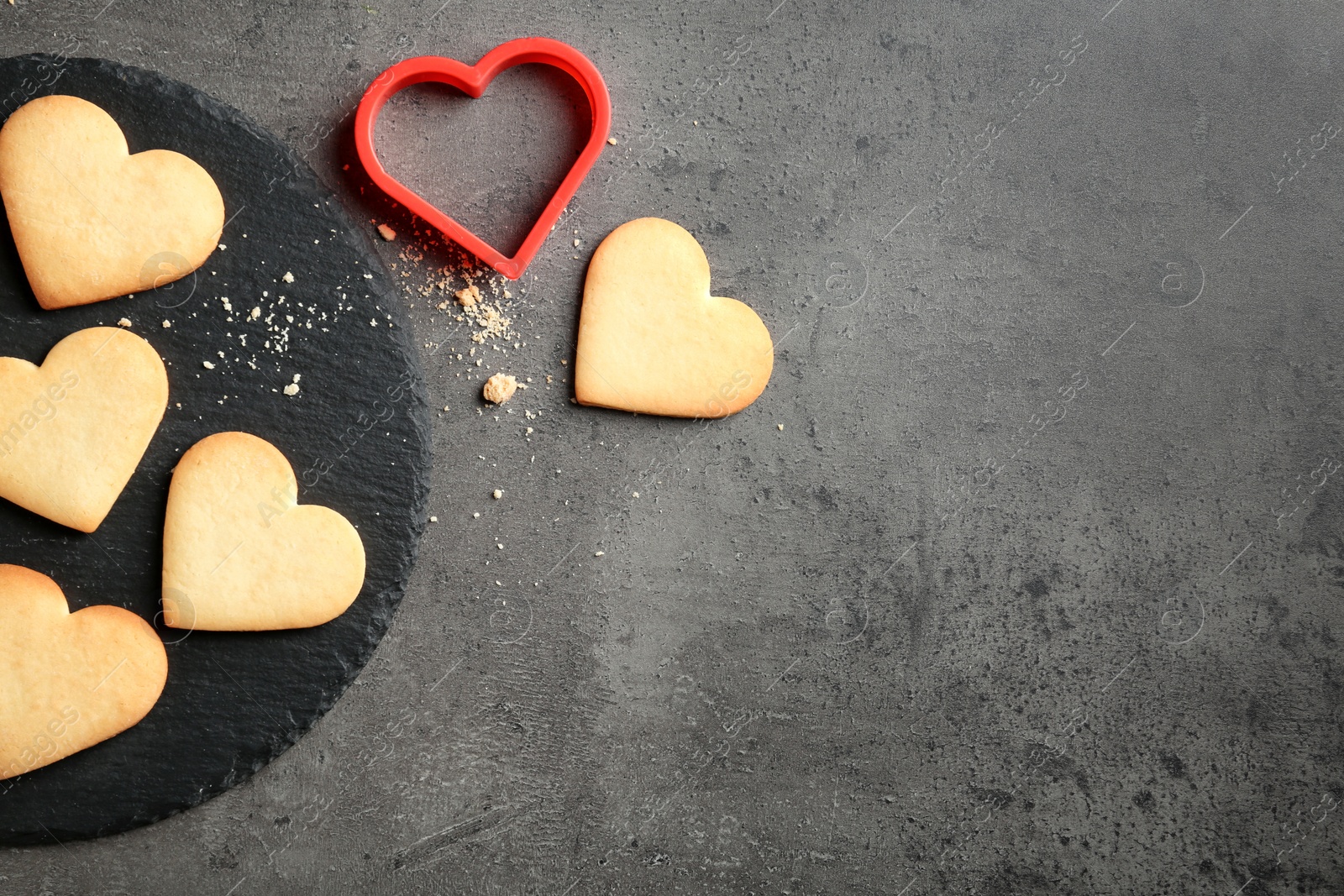 Photo of Flat lay composition with homemade heart shaped cookies and space for text on table