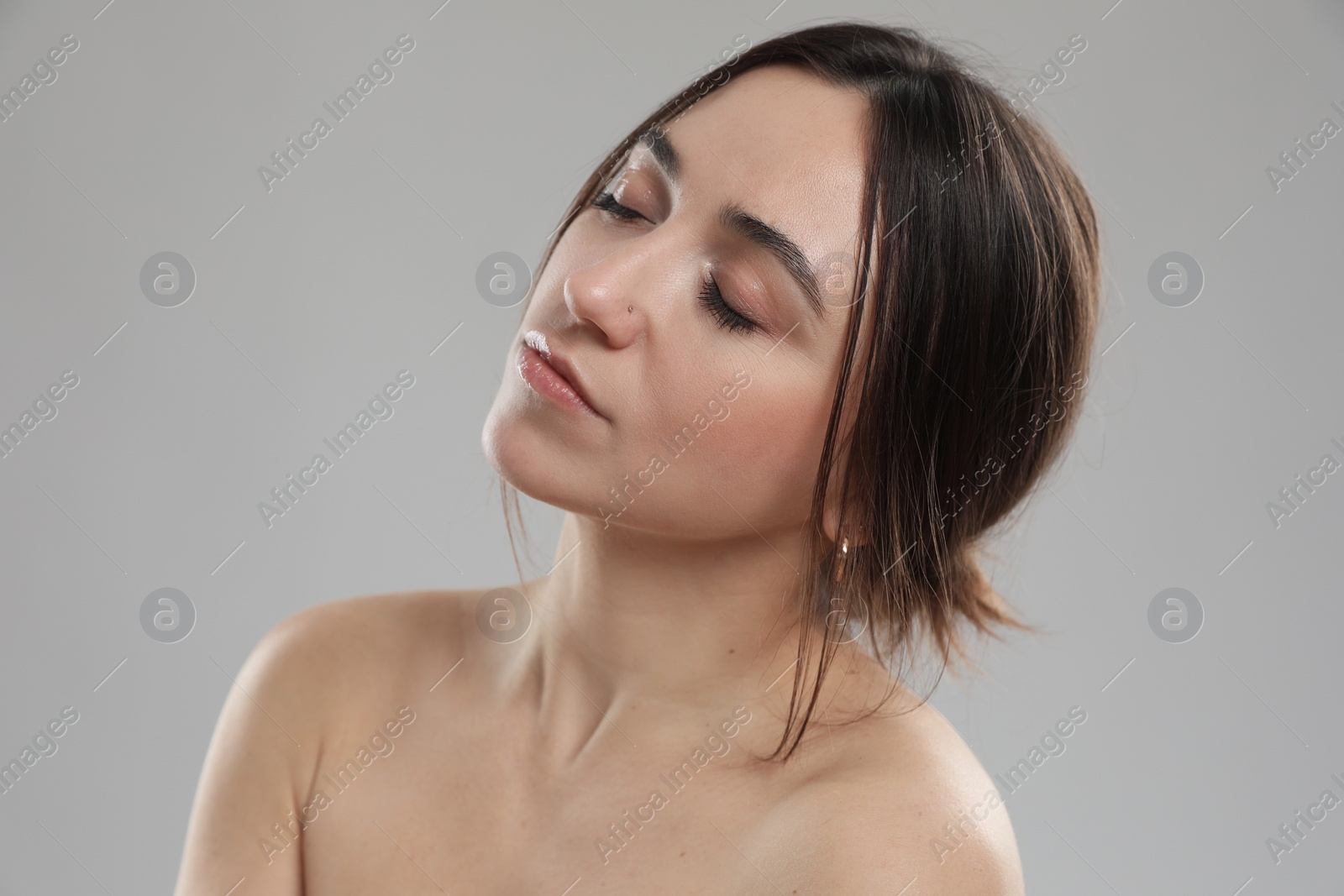 Photo of Portrait of beautiful woman on grey background