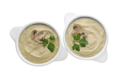 Photo of Delicious mushroom cream soup with parsley isolated on white, top view