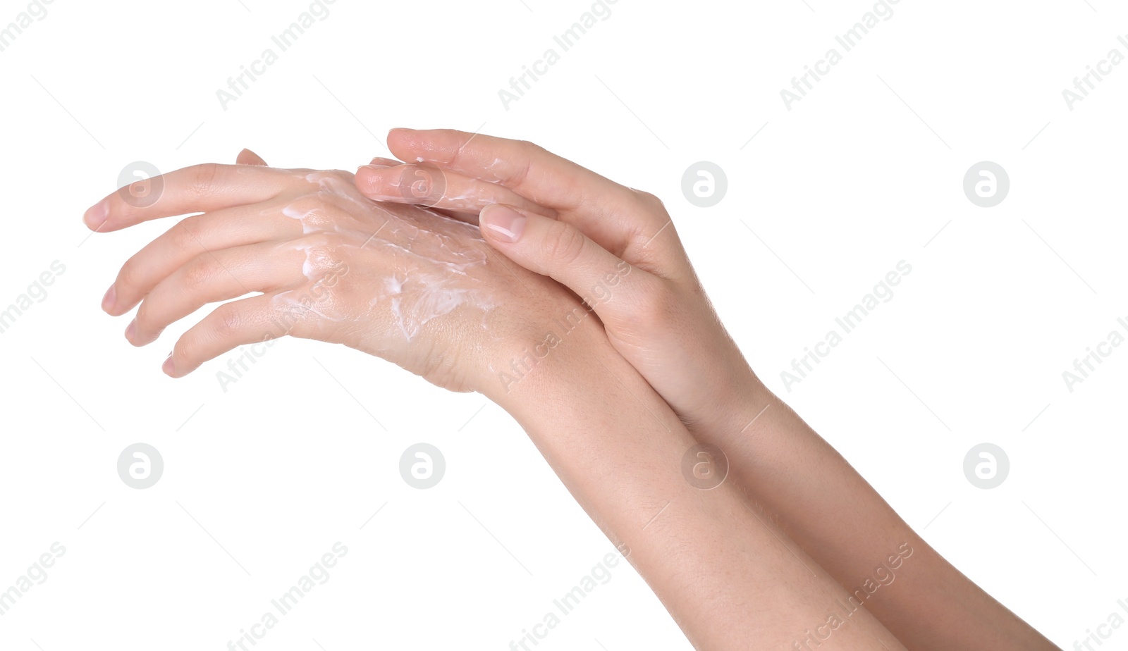 Photo of Young woman applying cream onto her hands on white background, closeup