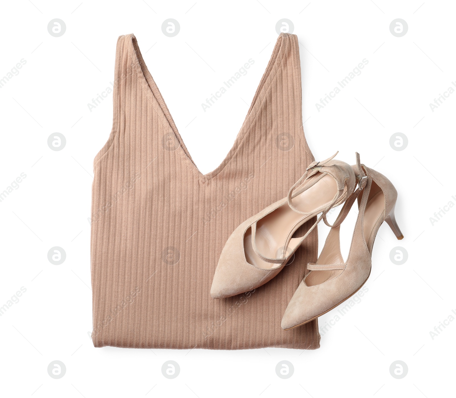 Photo of Folded dress and stylish high heeled shoes on white background, top view