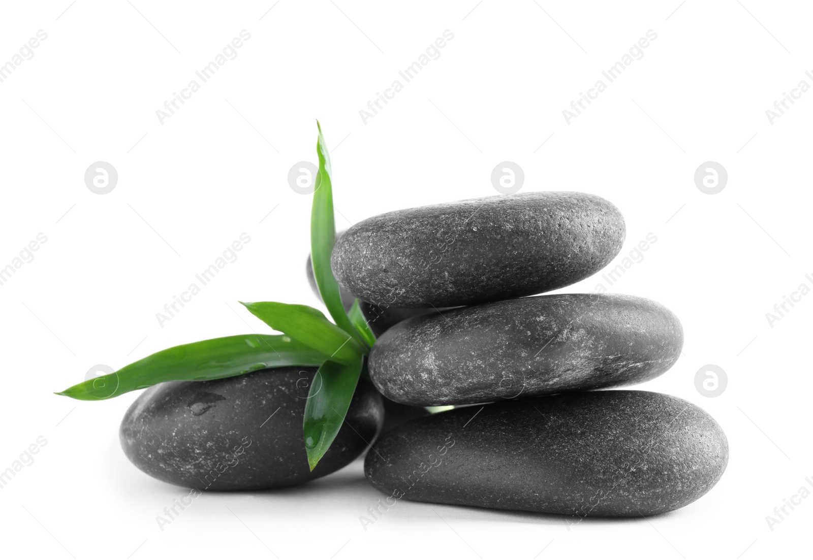 Photo of Stack of spa stones and leaves with water drops on white background