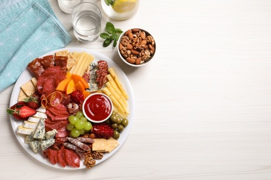 Photo of Plate of different appetizers with dip sauce on white wooden table, flat lay. Space for text