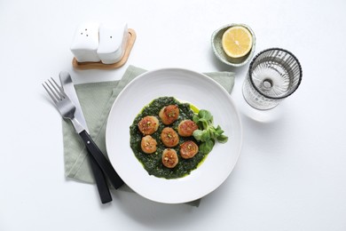 Delicious fried scallops in bowl served on white table, flat lay